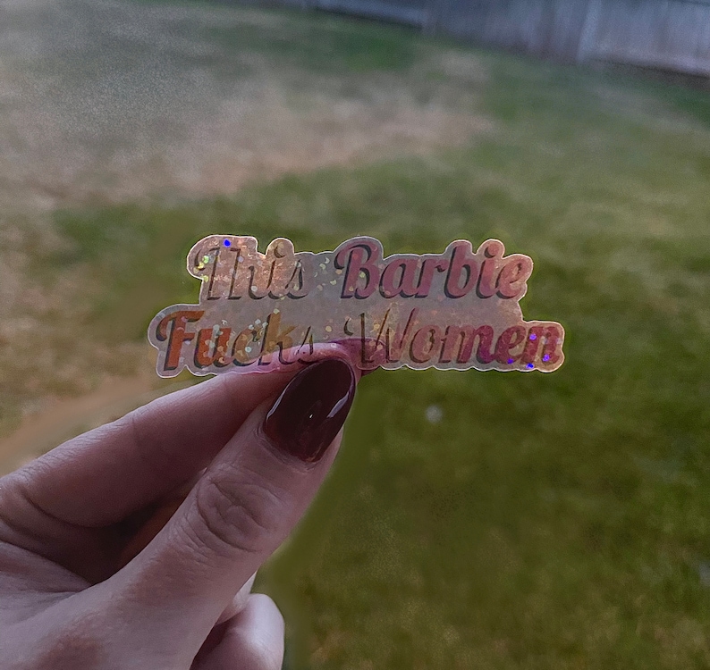 This Barbie F*cks Women- Lesbian Pride Clear Sticker | Holographic Glitter Laminated Waterproof Pride Sticker w/ Transparent Backing image 1