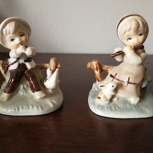 Pair of porcelain figurines -  countryside boy and girl playing music instruments