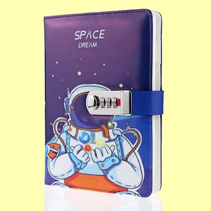 May include: Purple diary with a combination lock and an astronaut illustration. The cover says "SPACE DREAM".