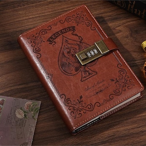 May include: Brown leather journal with a lock and key, featuring an ace of spades design and the word "Legends" on the cover.