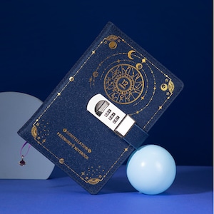 May include: A blue notebook with a gold constellation design and a combination lock. The notebook says "Constellation Password Notebook" on the front.