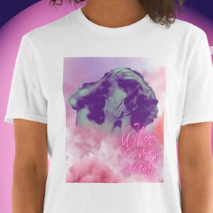 May include: White t-shirt featuring a graphic design with a person's face partially obscured by their hands. The design has a purple and pink color scheme with the text "Where is my mind" in a neon pink font.