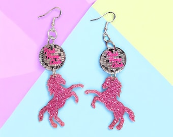 May include: Pink glitter horse earrings with a silver disco ball charm that says "Pink Pony Club".