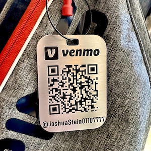 May include: A silver metal tag with a black and white QR code, the text "venmo" and the username "@JoshuaStein01107777".