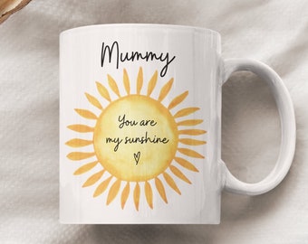 May include: White ceramic mug with a yellow sun graphic and the text "Mummy You are my sunshine" with a heart.