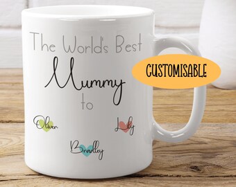May include: White ceramic mug with the text "The World's Best Mummy to" followed by three names: Oliver, Bradley, and Lily. Each name is surrounded by a heart in a different color: green, blue, and pink.