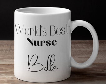 May include: White ceramic mug with black text that reads "World's Best Nurse Bella".