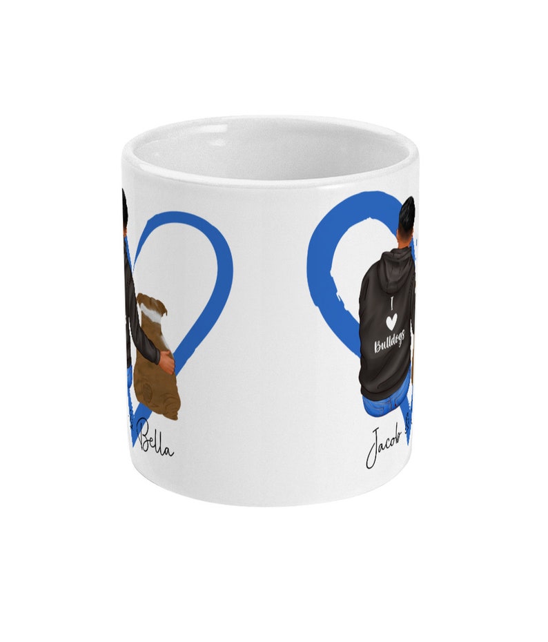 May include: White ceramic mug with a blue heart design. The heart is split in half with the names "Bella" and "Jacob" written on each side. The mug features a cartoon illustration of a couple holding hands.