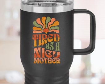 May include: Black stainless steel travel mug with a black handle. The mug features a retro-style graphic that says "Tired as a NICU Mother".