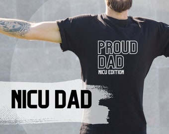 May include: A black t-shirt with the text "Proud Dad NICU Edition" in white. The person wearing the shirt is standing with their arms outstretched.
