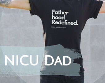 May include: A man wearing a black t-shirt with the text "Fatherhood Redefined. NICU Warrior Dad" printed on it. He is standing with his arms outstretched and wearing sunglasses and a black baseball cap. The text "NICU DAD" is written in white on a blue background.