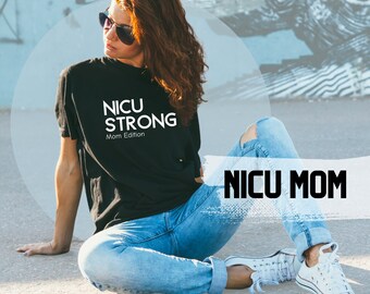 May include: A woman wearing a black t-shirt with the text "NICU STRONG Mom Edition" and blue jeans sits on a concrete surface. She is wearing sunglasses and white trainers. The text "NICU MOM" is written in white on a white and grey background.