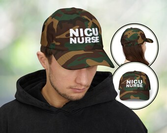 May include: A camouflage baseball cap with the text "NICU NURSE" in white lettering.