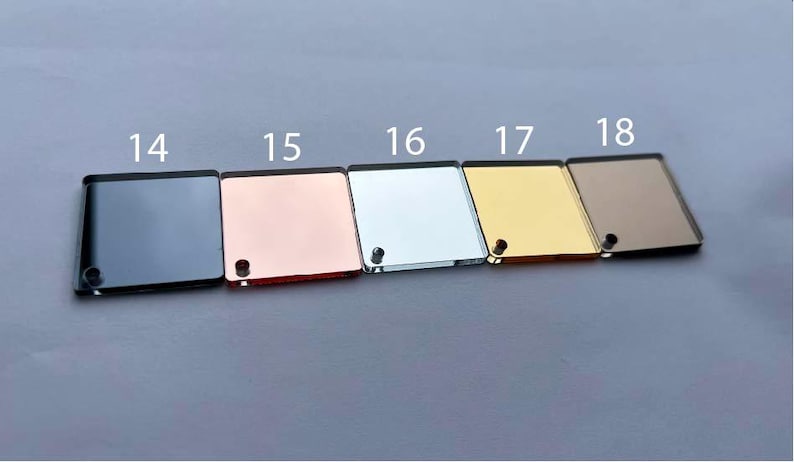 May include: Five square acrylic sheets in different colors: black, rose gold, silver, gold, and brown. The sheets are numbered 14 through 18.