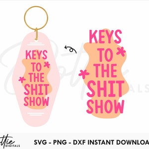 May include: Pink and orange key chain with the text "KEYS TO * THE SHIT SHOW" in pink lettering.
