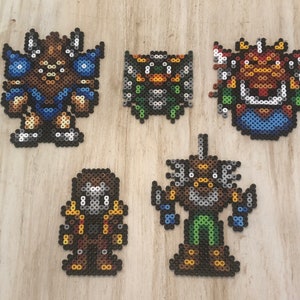 May include: Five pixel art characters made with colourful beads. The characters are a brown and blue warrior, a green and brown creature, a red and blue creature, a brown and gray creature, and a brown and green creature.