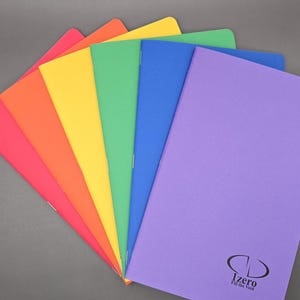 May include: A fan of colorful notebooks in red, orange, yellow, green, blue, and purple. The purple notebook has the text "Izero Fill the Void" printed on the bottom right corner. The notebooks are arranged in a fan shape.