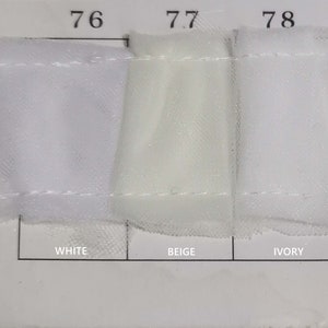 May include: Three fabric swatches labeled "76 White", "77 Beige", and "78 Ivory".