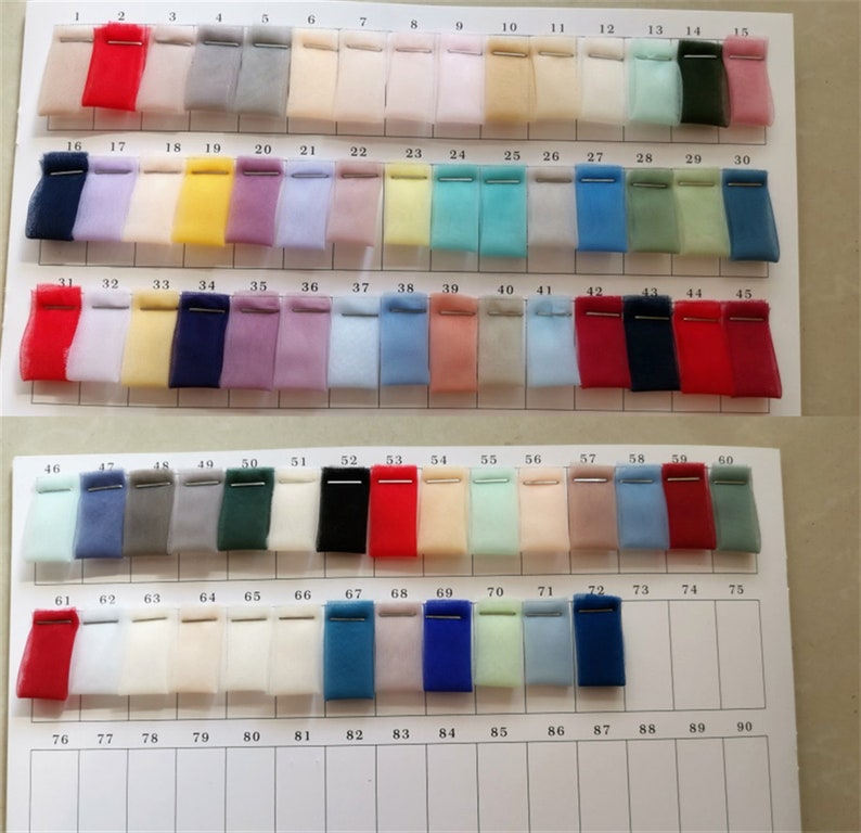 May include: A color chart of 90 fabric swatches, arranged in rows of 15. The swatches are made of a sheer, lightweight fabric, possibly tulle or organza. The colors range from light to dark, and include shades of red, blue, green, yellow, pink, and white.