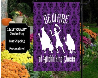 May include: Purple garden flag with a white silhouette of three ghosts and the text "Beware of Hitchhiking Ghosts".