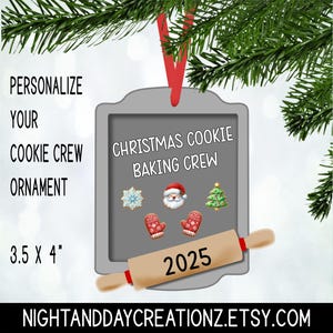 May include: A gray Christmas ornament with a red ribbon, featuring the text "Christmas Cookie Baking Crew." It includes festive graphics and a rolling pin with "2025." The ornament measures 3.5 x 4 inches.