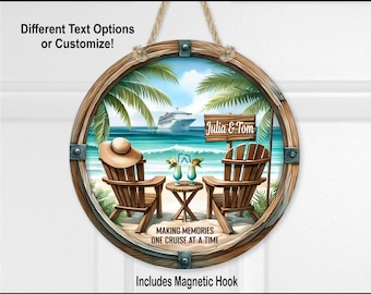 May include: A round MDF sign featuring a beach scene with two wooden chairs, a small table with drinks, a sun hat, and a cruise ship in the distance. The sign includes the text Julia & Tom and Making Memories One Cruise At A Time.