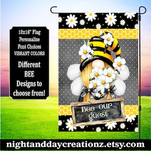 May include: A 12x18 inch garden flag with a bee gnome design. The gnome is wearing a black and yellow bee hat and holding a bouquet of white daisies. The flag has a black background with yellow honeycomb and white daisy patterns. The text "Bee our guest" is written on a chalkboard sign.