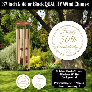 May include: Gold or black wind chimes, 37 inches long, hanging in a garden setting. The chimes have a brown top and a round emblem that says "Happy 50th Anniversary". The image also includes text that says "Personalize with Names Year or message!"
