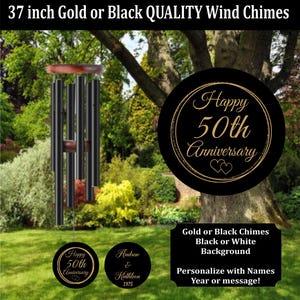 May include: Black wind chimes, 37 inches long, with a wooden top and accents, hanging in a garden setting. The image includes a black circle with "Happy 50th Anniversary" in gold script. Additional text: "Personalize with Names Year or message!"