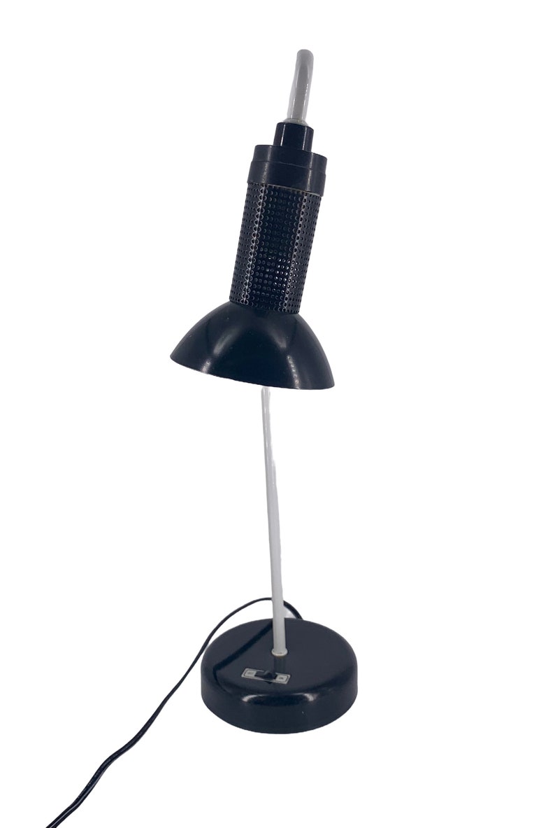 a black desk lamp with a white base