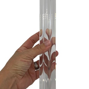 May include: A clear glass prism with a faceted design. The prism is approximately 10 inches long and has a silver metal cap at the top.