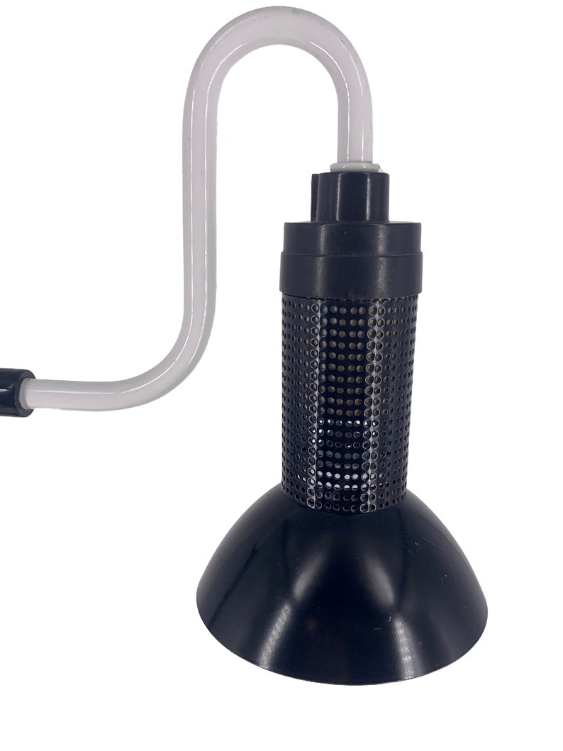 a black lamp with a white cord attached to it
