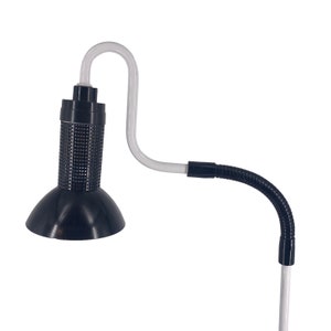a black and white lamp with a white cord