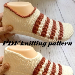 May include: Knitting pattern for a pair of beige and brown striped slipper socks. The pattern is available as a PDF download.
