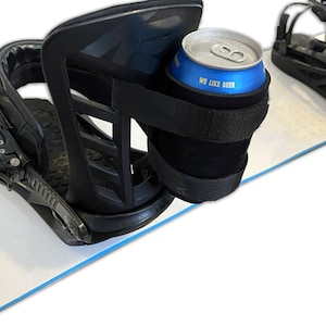 Beer Strapped to Snowboard Binding