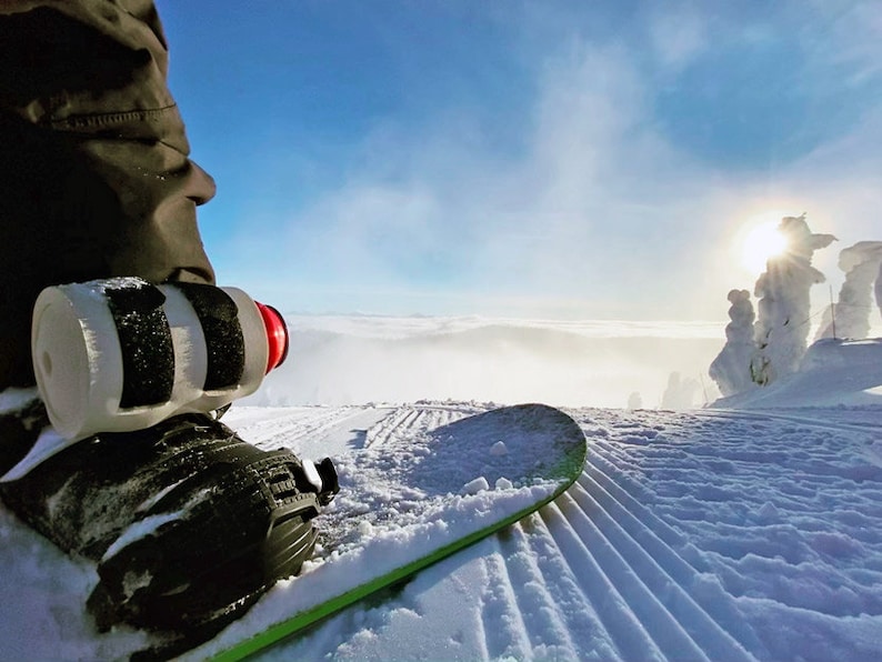 Beer Binding Pro strapped to Snowboard on Mountain saint bernard style
