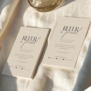 May include: Two beige referral cards with the text "Refer a Friend" in a stylish font. The cards also include the text "And get $10 off your next appointment" and "Pass this card onto a friend and ask them to mention you when booking."