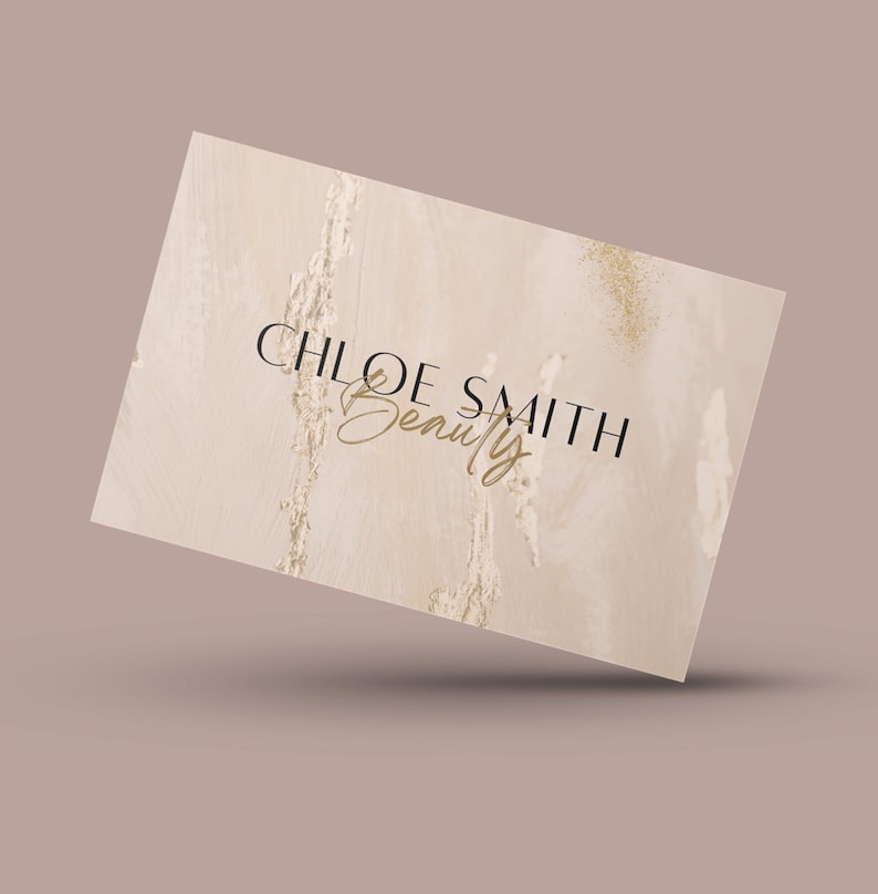 May include: A beige business card with a marble-like texture and gold glitter accents. The text "CHLOE SMITH Beauty" is printed in black and gold.