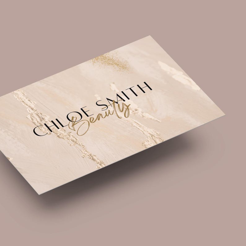 May include: A beige business card with a marble-like background and gold glitter accents. The text "CHLOE SMITH Beauty" is printed in black and gold.