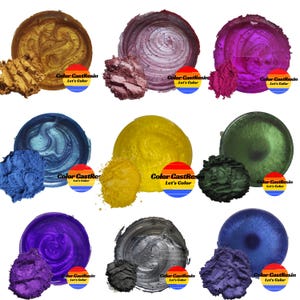 May include: Twelve small jars of metallic paint in various colors, including gold, purple, blue, green, and silver. Each jar has a small sample of the paint next to it and a label that says "Color CastResin Let's Color".
