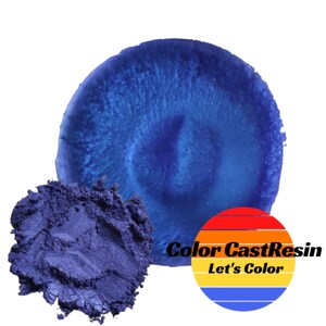 May include: A sample of blue mica powder pigment for resin art. The powder is a deep blue color with a slight purple hue. The image also shows a blue resin sample with the Color Cast Resin logo.