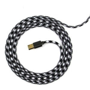 May include: A black and white braided USB cable with a USB-A connector. The cable is coiled up on a white background.