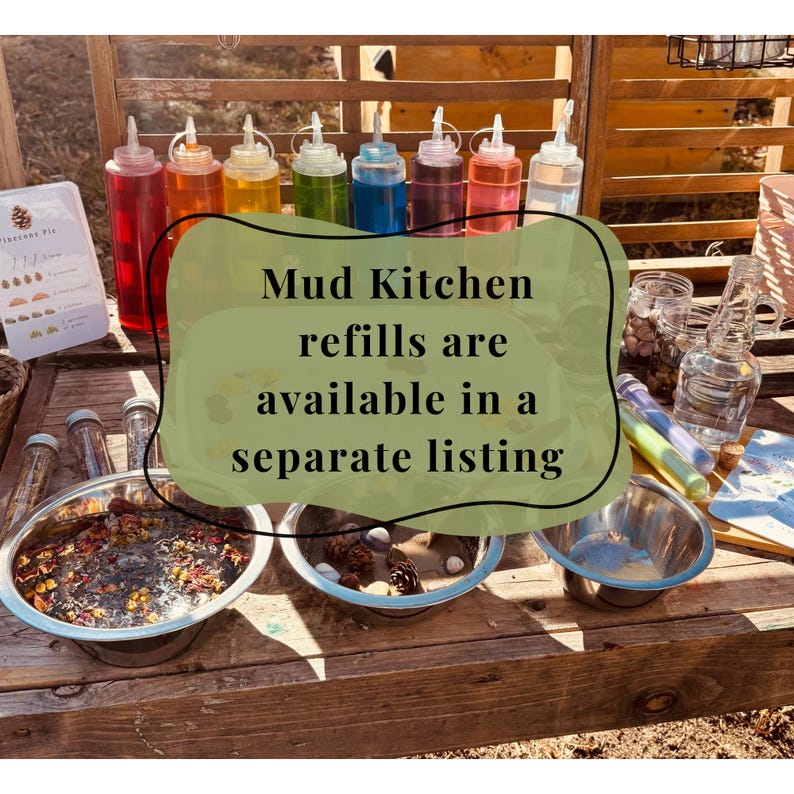 May include: A collection of clear plastic squeeze bottles filled with various colored liquids, three stainless steel bowls containing natural materials like pinecones and petals, and glass jars on a wooden surface with text reading Mud Kitchen refills are available in a separate listing.