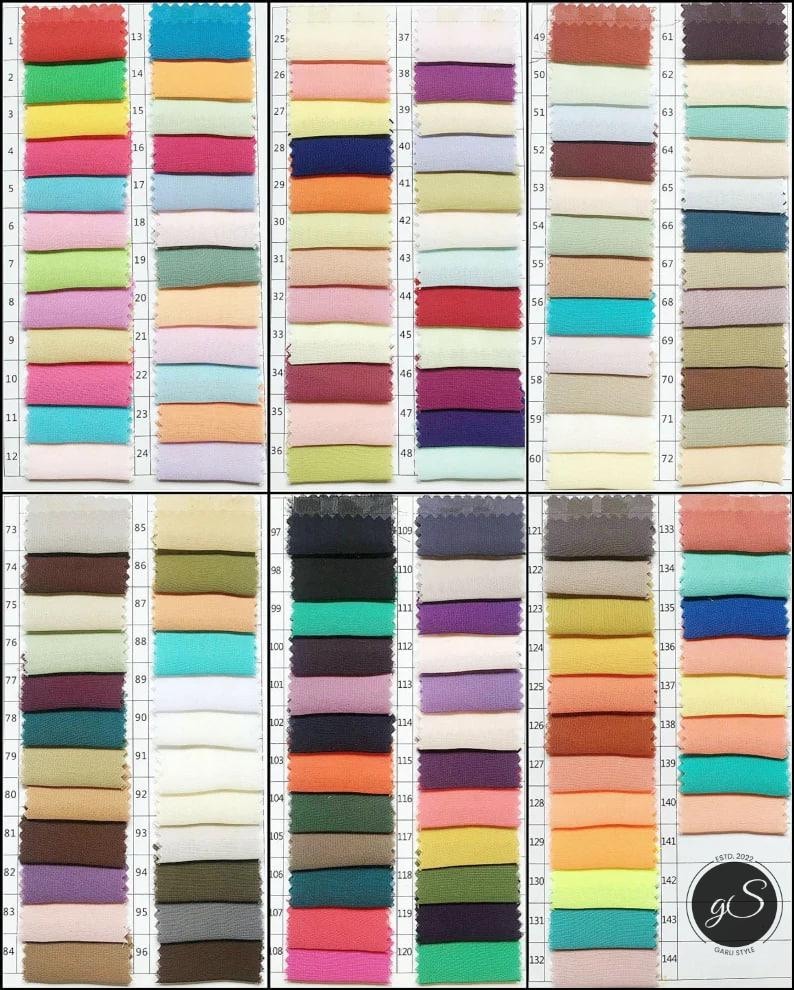 May include: A color swatch chart featuring 144 fabric samples in a variety of colors. The samples are arranged in a grid, with each square displaying a different hue, ranging from pastels to vibrant shades. The chart includes a logo in the bottom right corner.