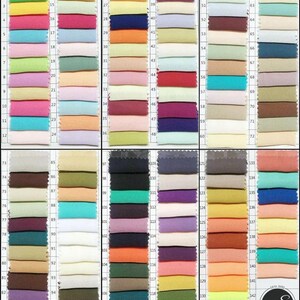 May include: A color swatch chart featuring 144 fabric samples in a variety of colors. The samples are arranged in a grid, with each swatch labeled with a number. The colors range from vibrant to muted tones, including blues, greens, pinks, and oranges.
