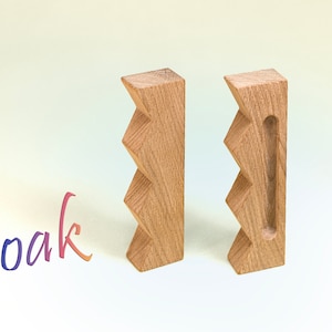 May include: Two wooden blocks with a zig-zag pattern. The block on the right has a rectangular cutout.