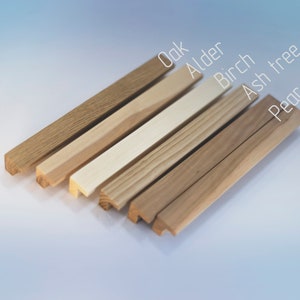 May include: Close-up of six different wood samples, arranged in a fan shape. The wood types are labeled: Oak, Alder, Birch, Ash tree, and Pear.