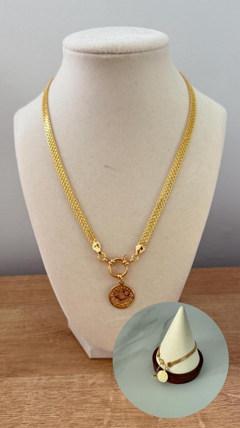 May include: A gold-colored necklace with a woven chain design and a circular pendant featuring an embossed design. The necklace is displayed on a mannequin. A matching bracelet with a similar pendant is also shown.