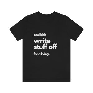 May include: Black t-shirt with white text that reads "cool kids write stuff off for a living."
