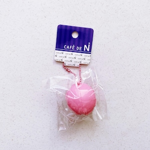 May include: A white ceramic mug with a black handle and the text "But First, Coffee" in a bold, black font. The mug is set against a blurred background, suggesting a cozy setting.